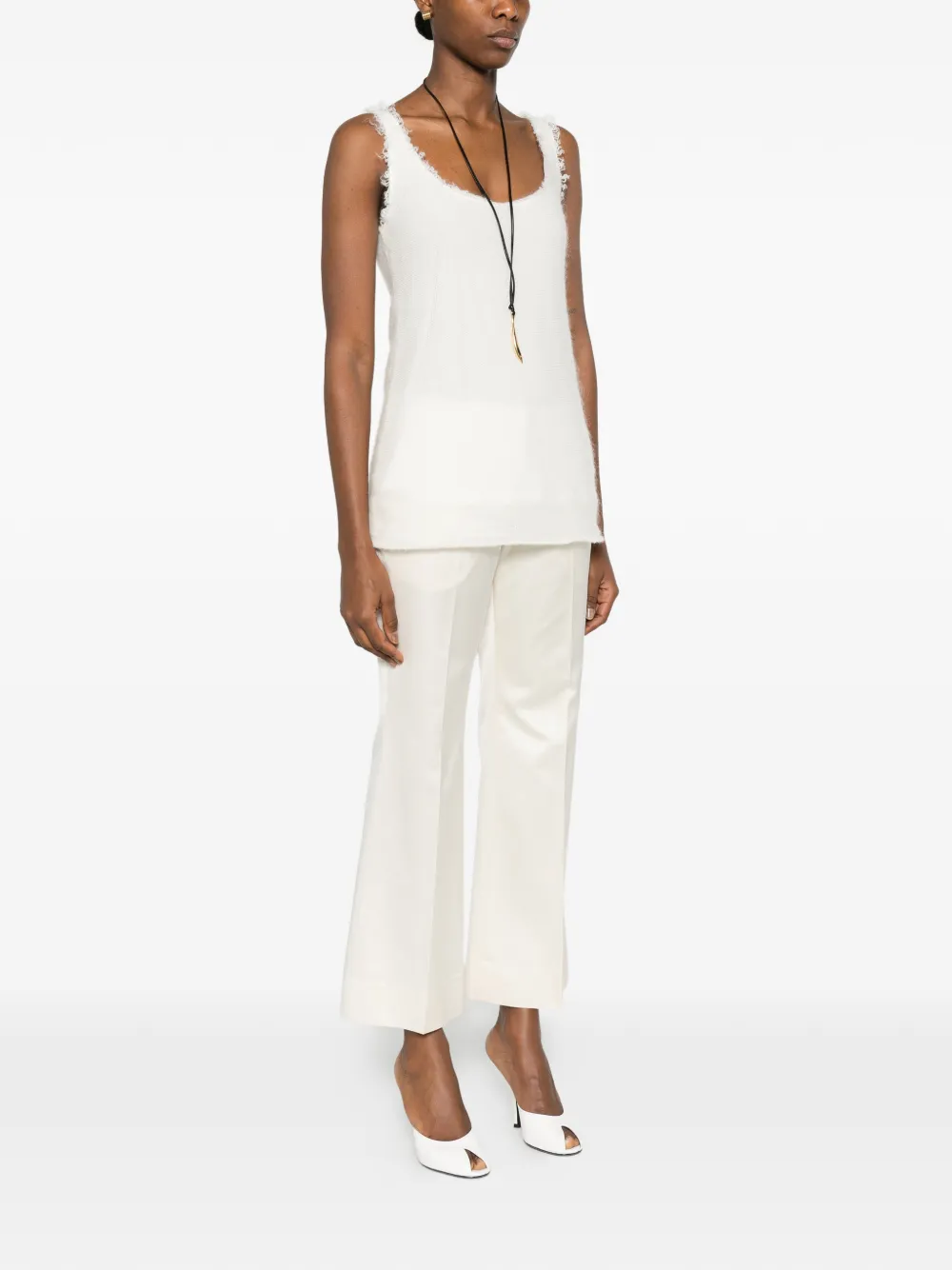White tops worn by a person, showing the tops' fit