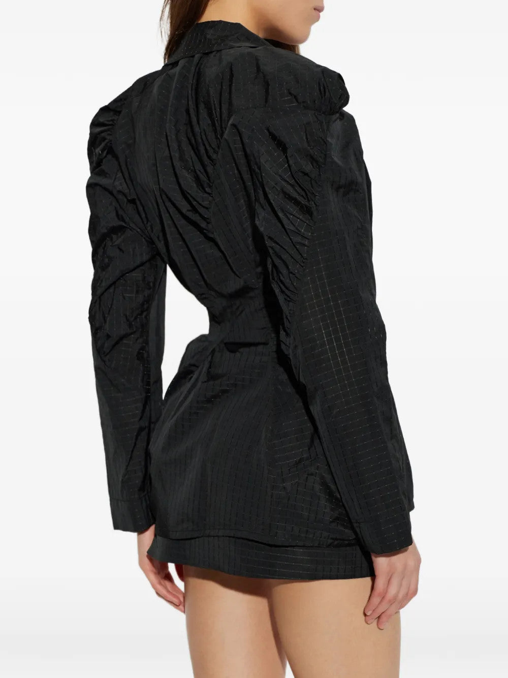 Black jacket worn by a person, showing the jacket fit