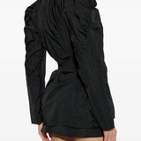Black jacket worn by a person, showing the jacket fit