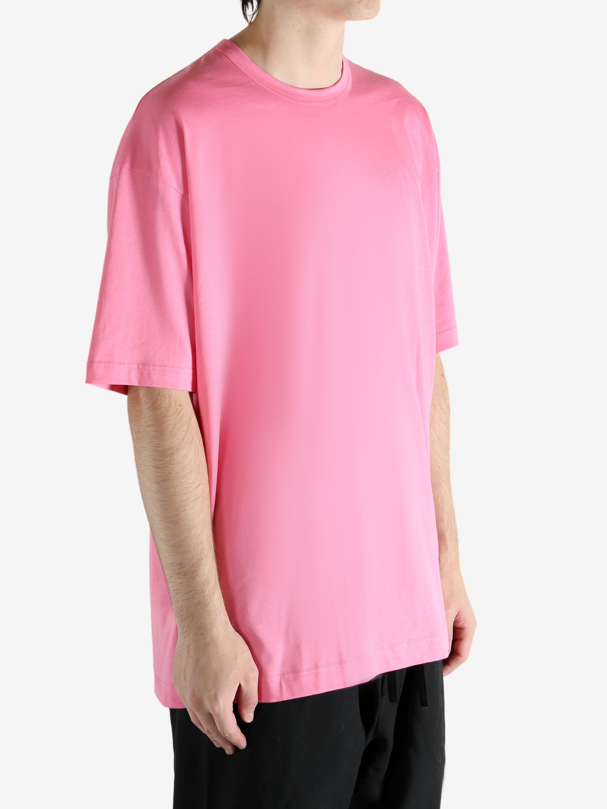 Pink t-shirt worn by a person, showing the shirt's fit