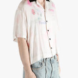 White shirt worn by a person, showing the shirt's fit