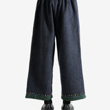 Navy pants worn by a person, showing the pants's fit