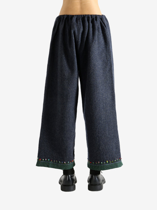 Navy pants worn by a person, showing the pants's fit