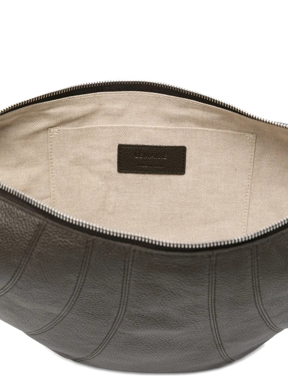 Close up of the grey bag, showing texture of the leather and cotton fabric