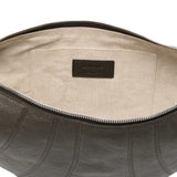 Close up of the grey bag, showing texture of the leather and cotton fabric