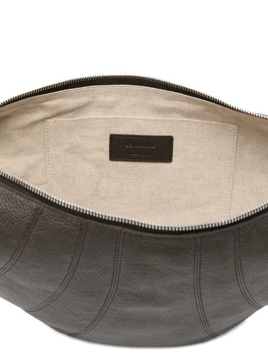 Close up of the grey bag, showing texture of the leather and cotton fabric