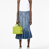 Green bag worn by a person, showing the bag's fit