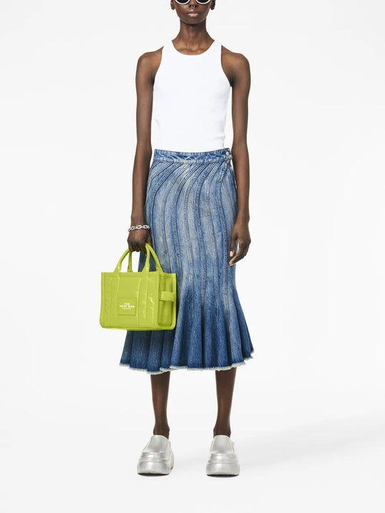 Green bag worn by a person, showing the bag's fit
