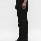 Black pants worn by a person, showing the pants fit