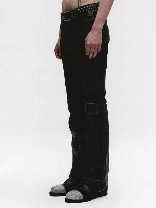 Black pants worn by a person, showing the pants fit