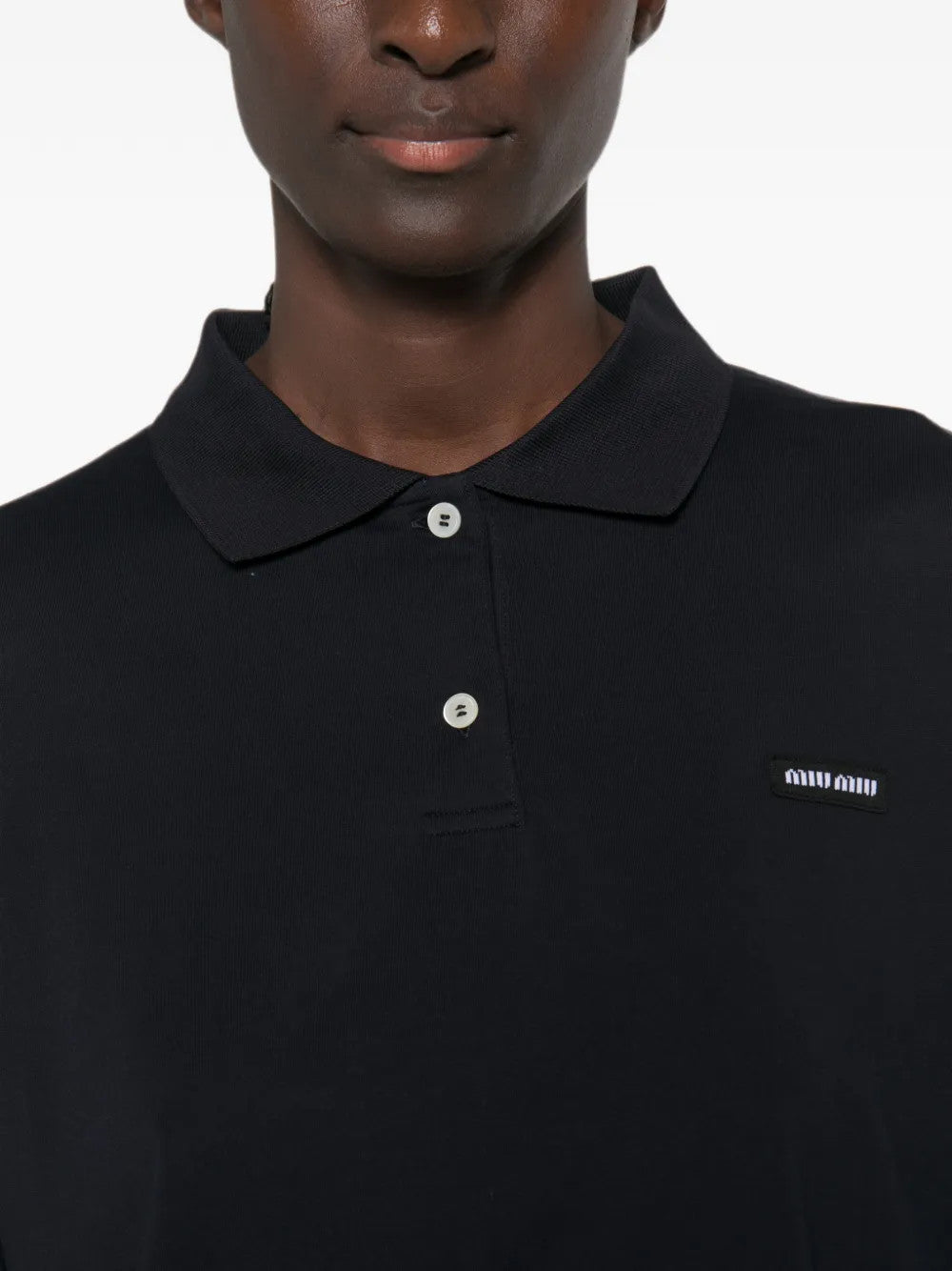 Navy shirt worn by a person, showing the shirt fit