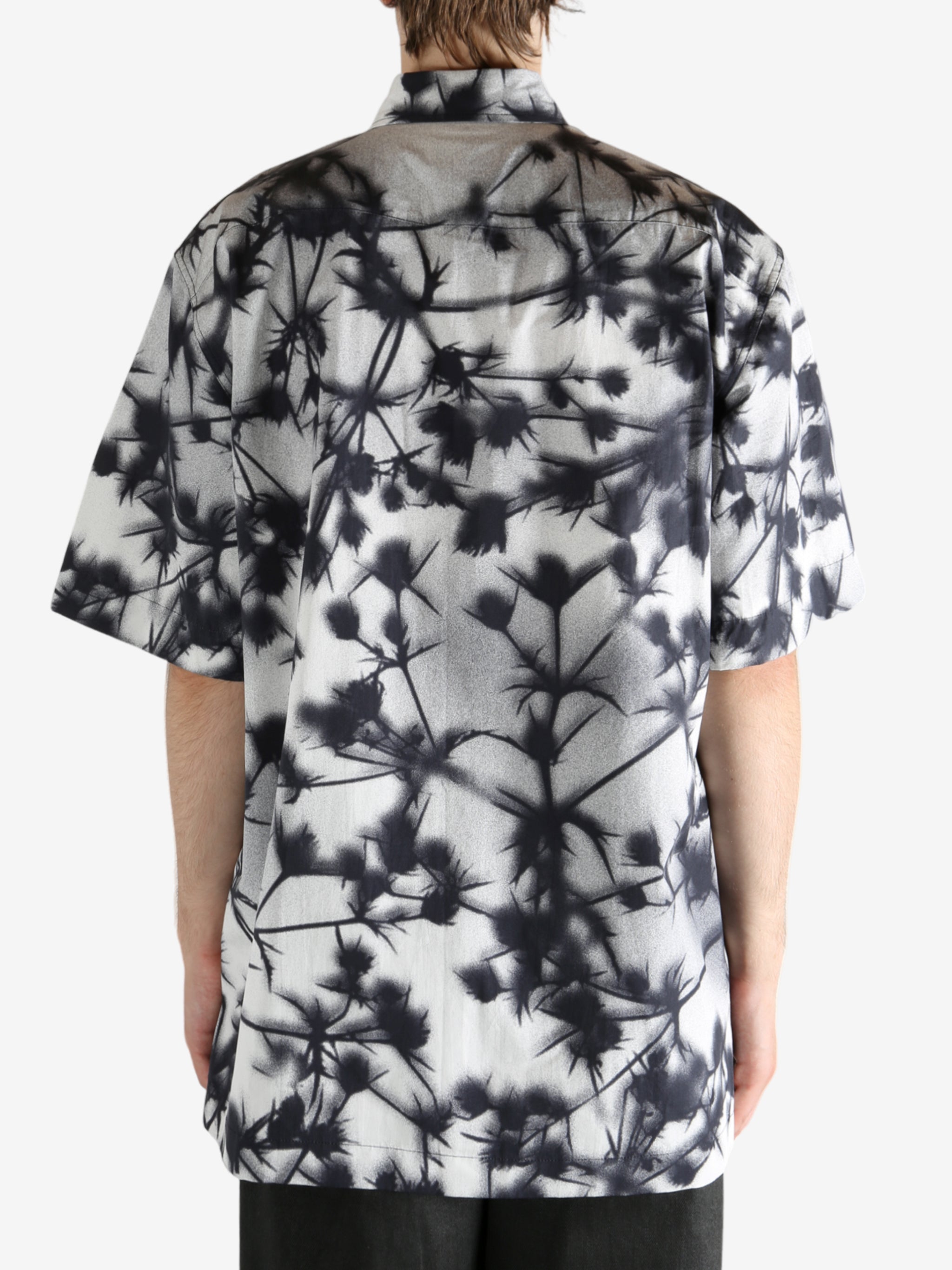 Black shirt worn by a person, showing the shirt's fit