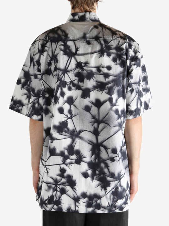 Black shirt worn by a person, showing the shirt's fit