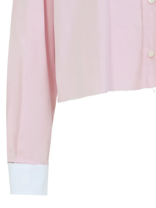 Close up of the pink shirt, showing texture of the cotton fabric