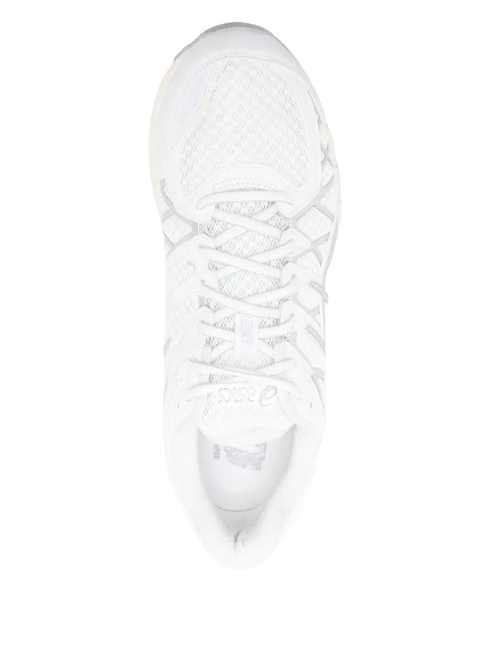 Close up of white sneakers, showing texture of the rubber and polyurethane fabric