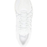 Close up of white sneakers, showing texture of the rubber and polyurethane fabric