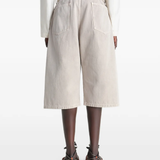 Beige wide-leg pant worn by a person, showing the pants fit