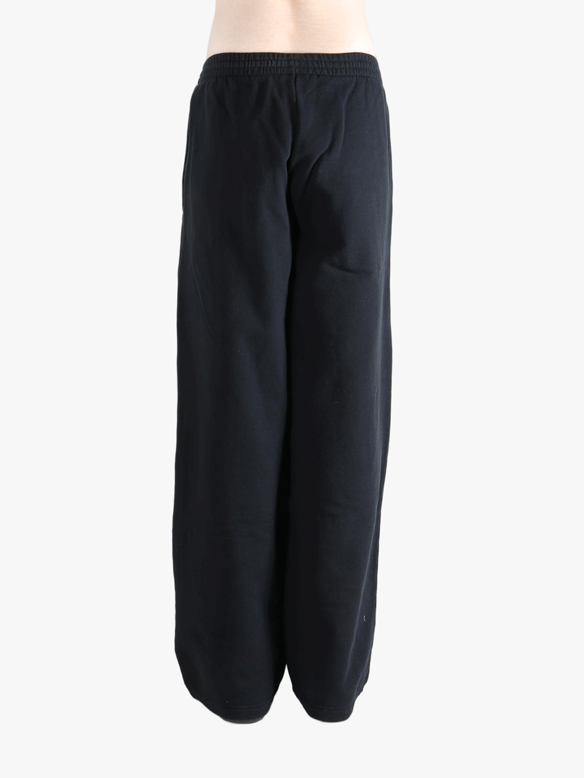 Black pants worn by a person, showing the pants fit