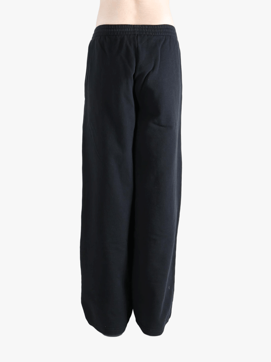 Black pants worn by a person, showing the pants fit