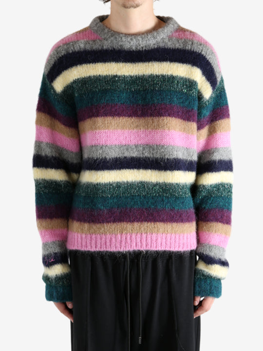 Green knitwear worn by a person, showing the knitwear's fit