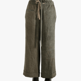 Green pants worn by a person, showing the pants' fit