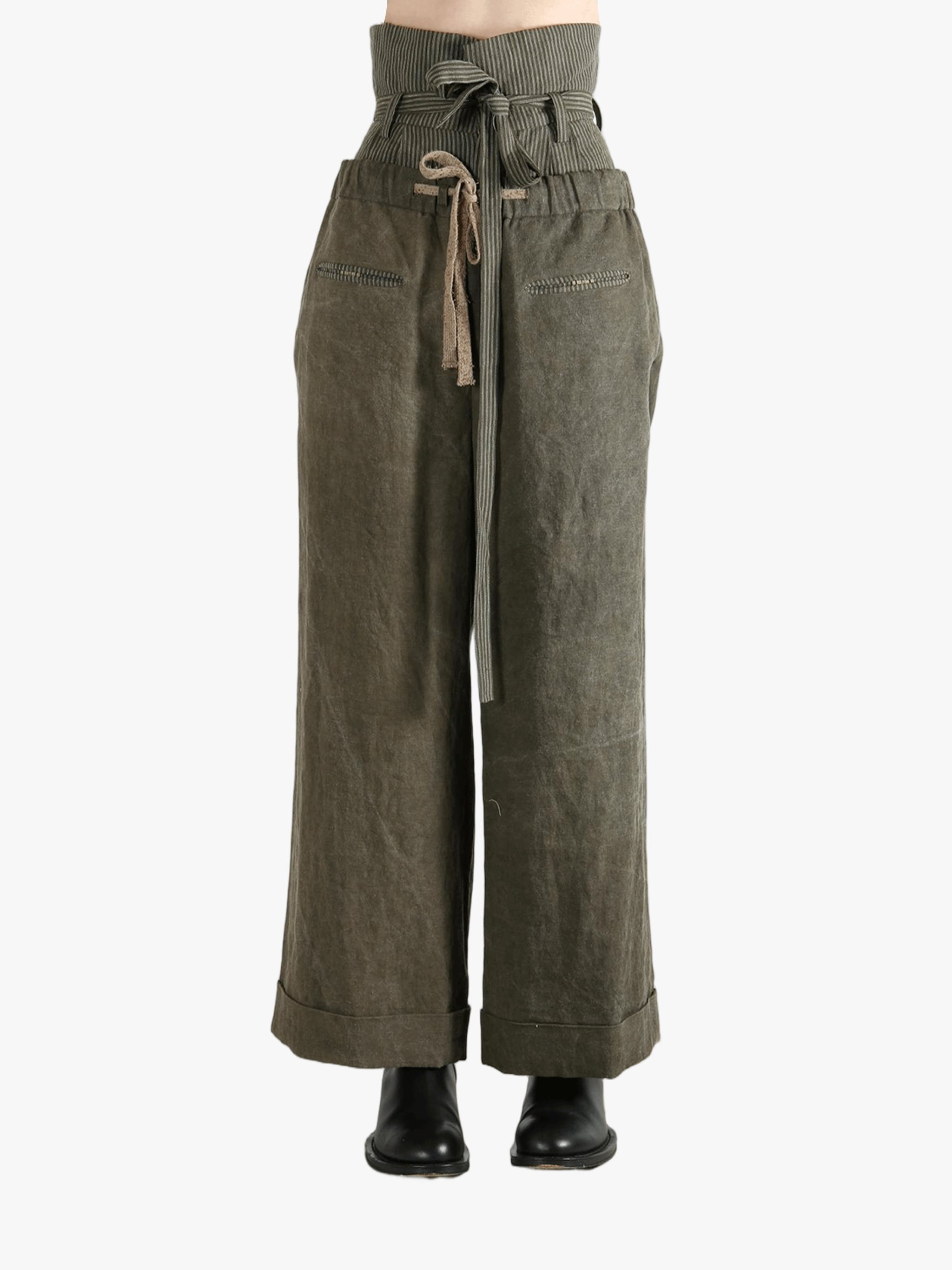 Green pants worn by a person, showing the pants' fit