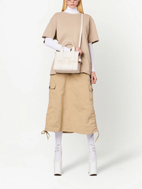 White bag worn by a person, showing the bag's fit