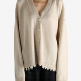 Tan knitwear worn by a person, showing the knitwear fit