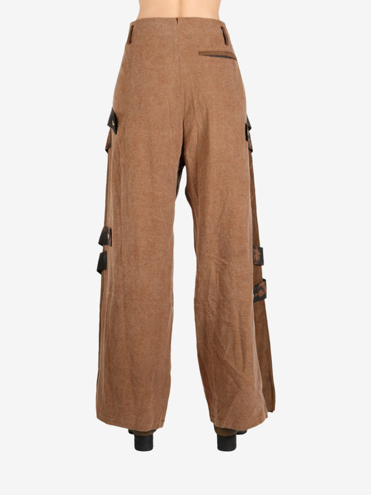 Brown pant worn by a person, showing the pant’s fit