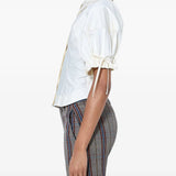 White top worn by a person, showing the top fit