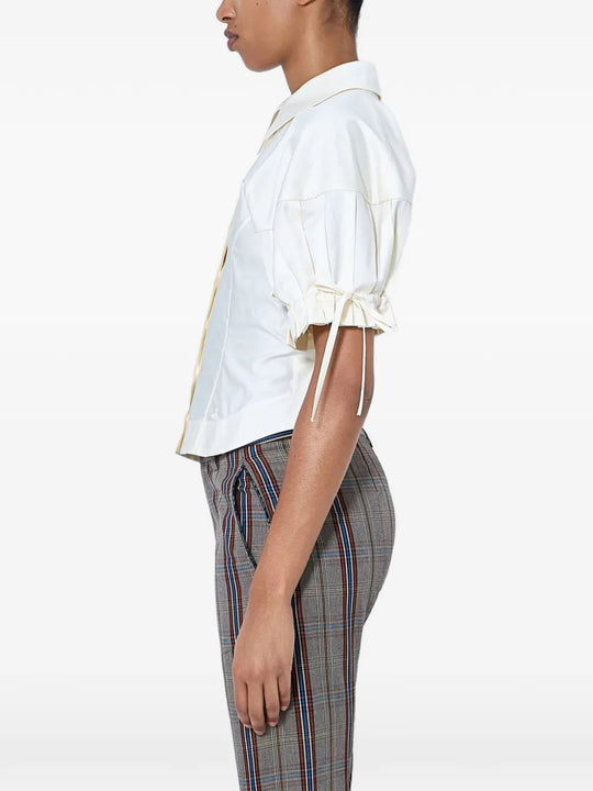 White top worn by a person, showing the top fit