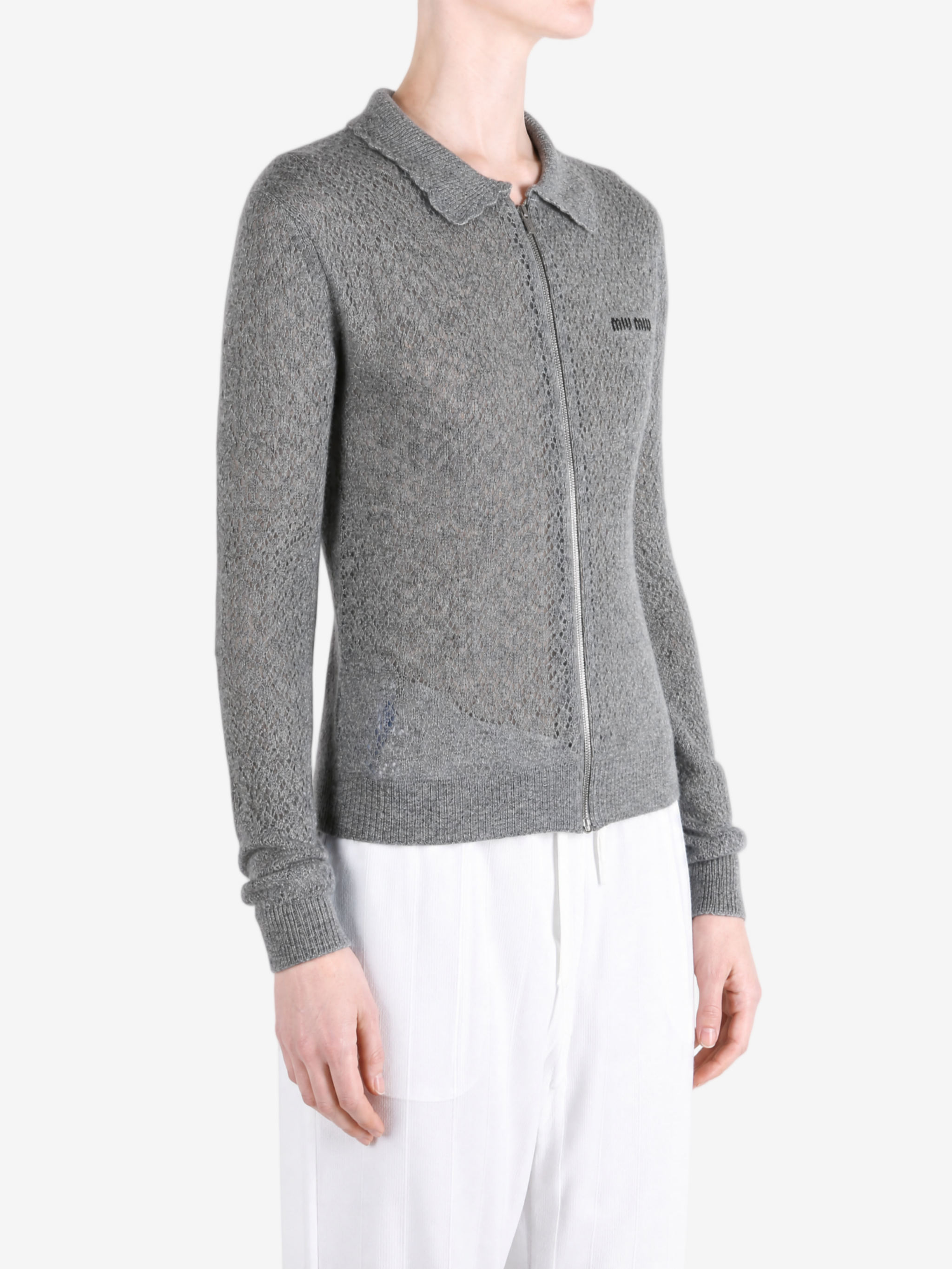 Grey knitwear worn by a person, showing the knitwear fit