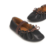 Close up of black flats, showing texture of the Calf Leather fabric