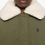 Green jacket worn by a person, showing the jacket fit