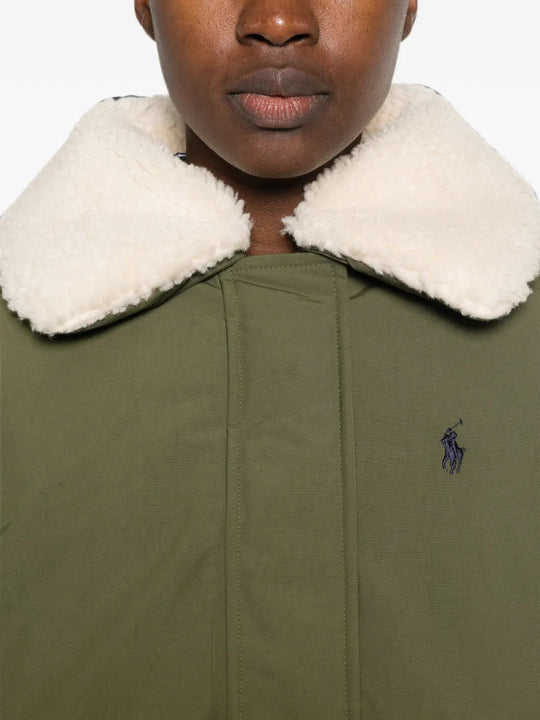 Green jacket worn by a person, showing the jacket fit