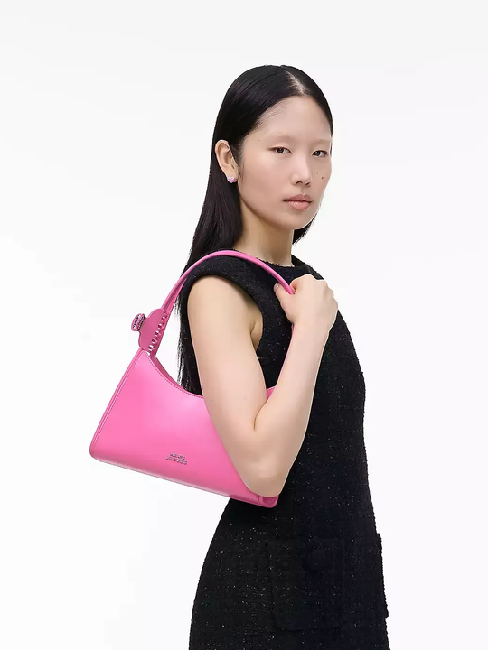 Pink bag worn by a person, showing the bag's fit