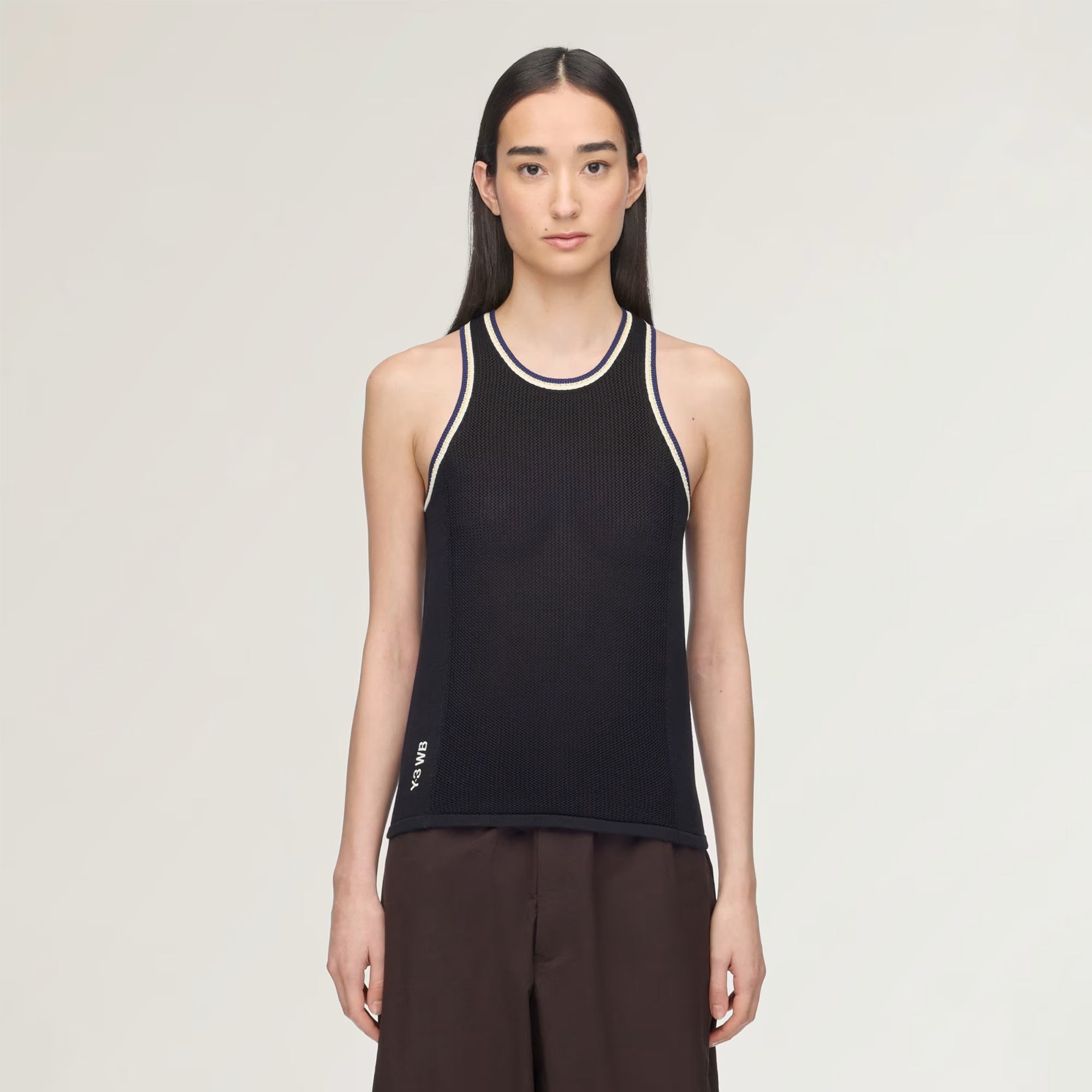 Black top worn by a person, showing the top fit