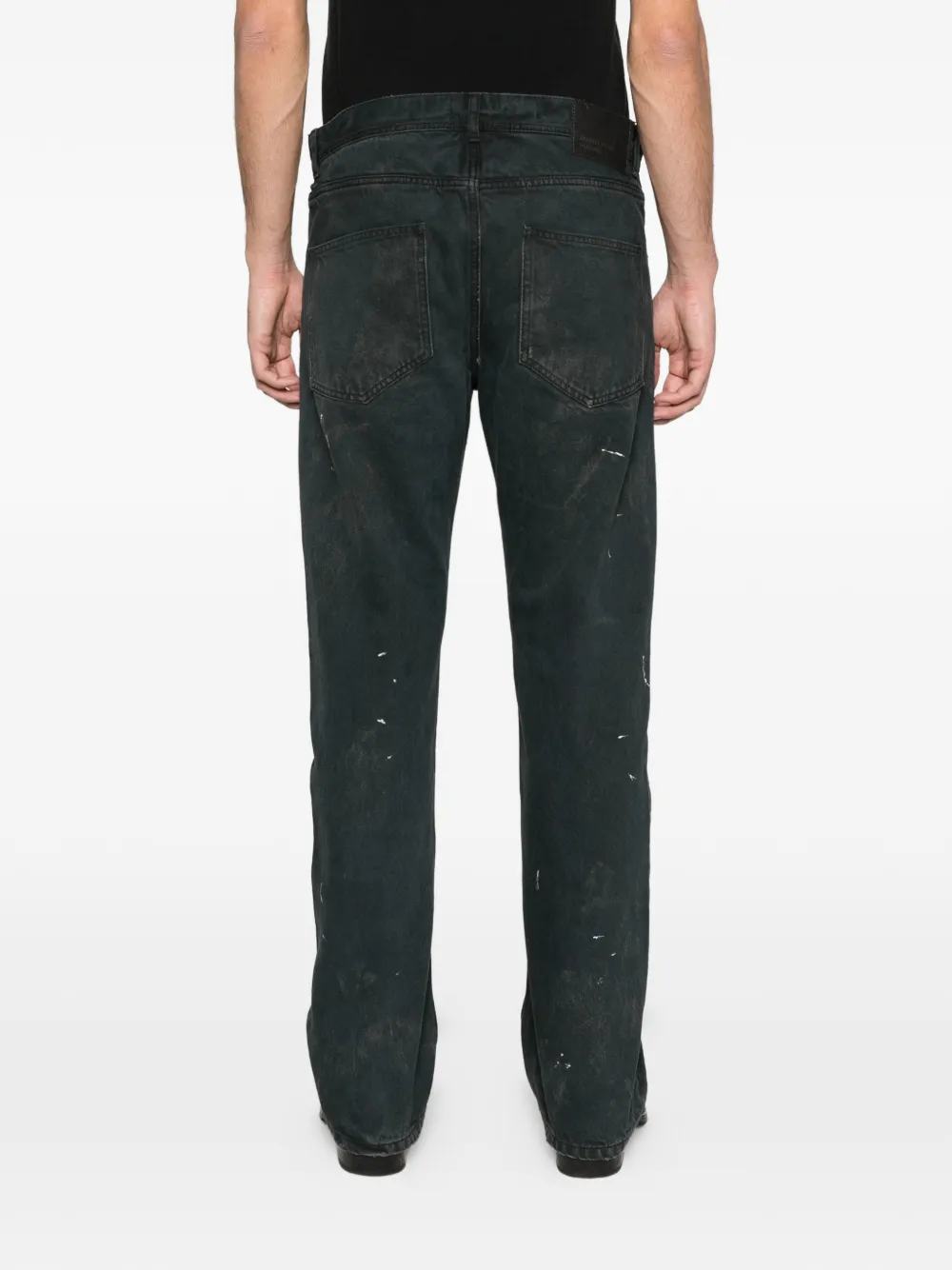 Black jeans worn by a person, showing the jeans fit