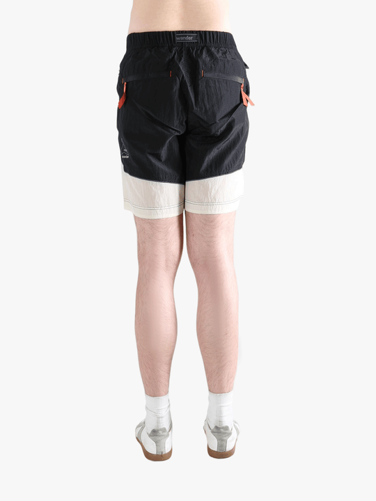 Black pants worn by a person, showing the pants's fit