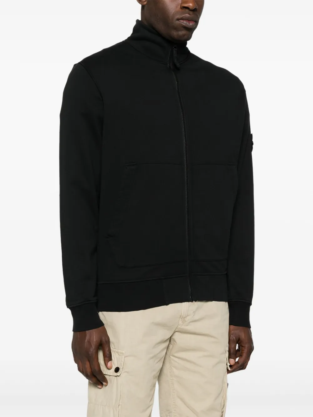 Black jacket worn by a person, showing the jacket fit