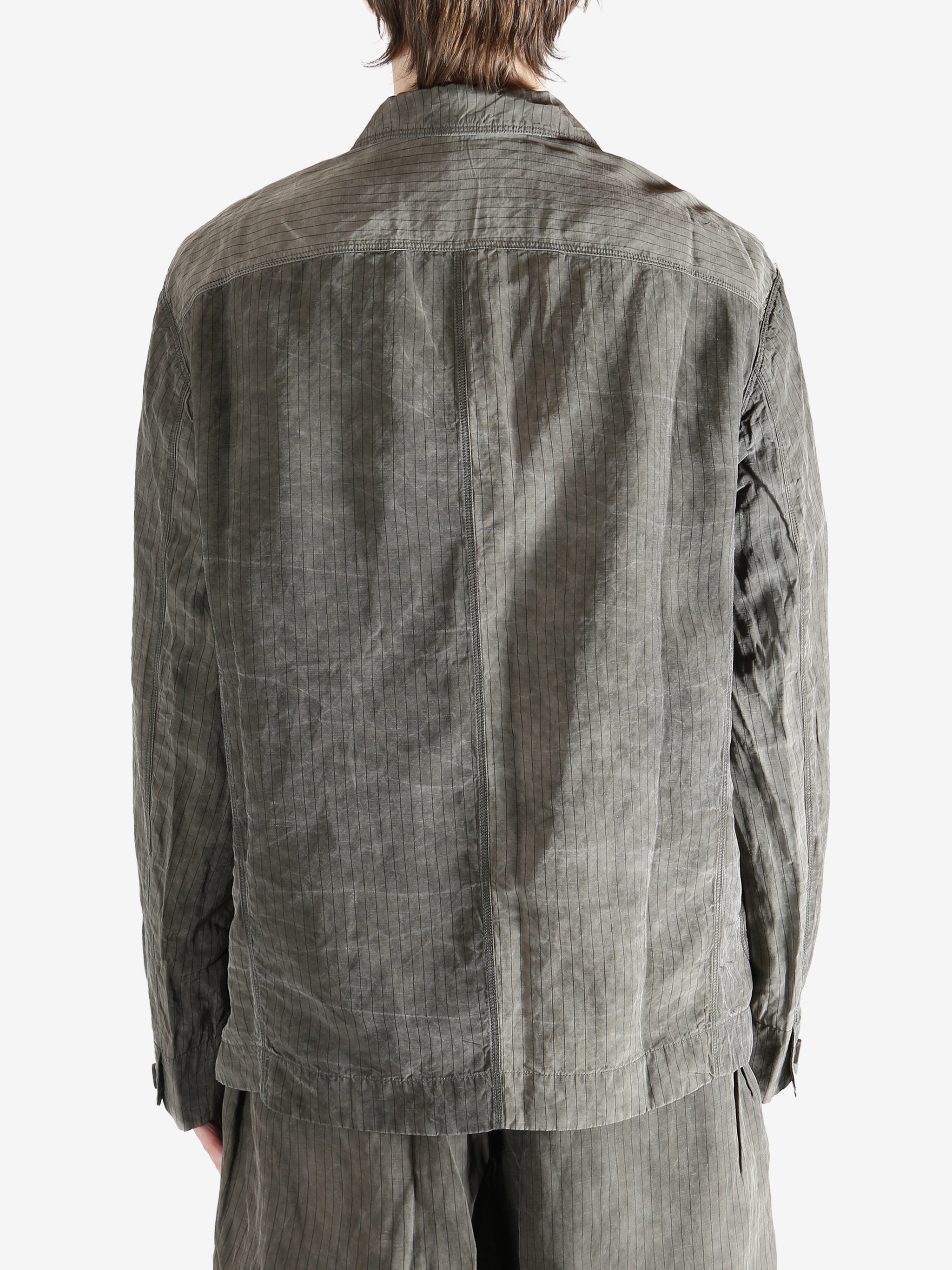 Grey jacket worn by a person, showing the jacket fit