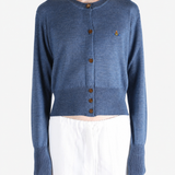 Blue knitwear worn by a person, showing the knitwear fit
