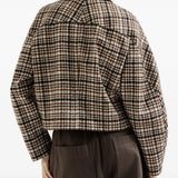 Brown jacket worn by a person, showing the jacket fit