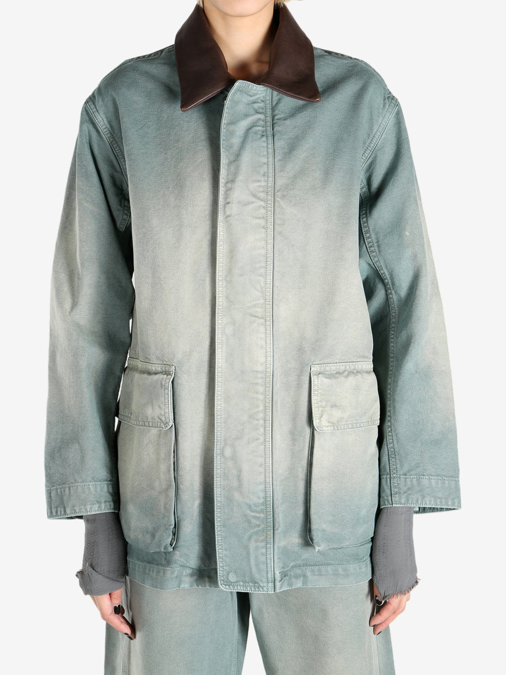 Green jacket worn by a person, showing the jacket's fit