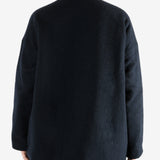 Black jacket worn by a person, showing the jacket fit
