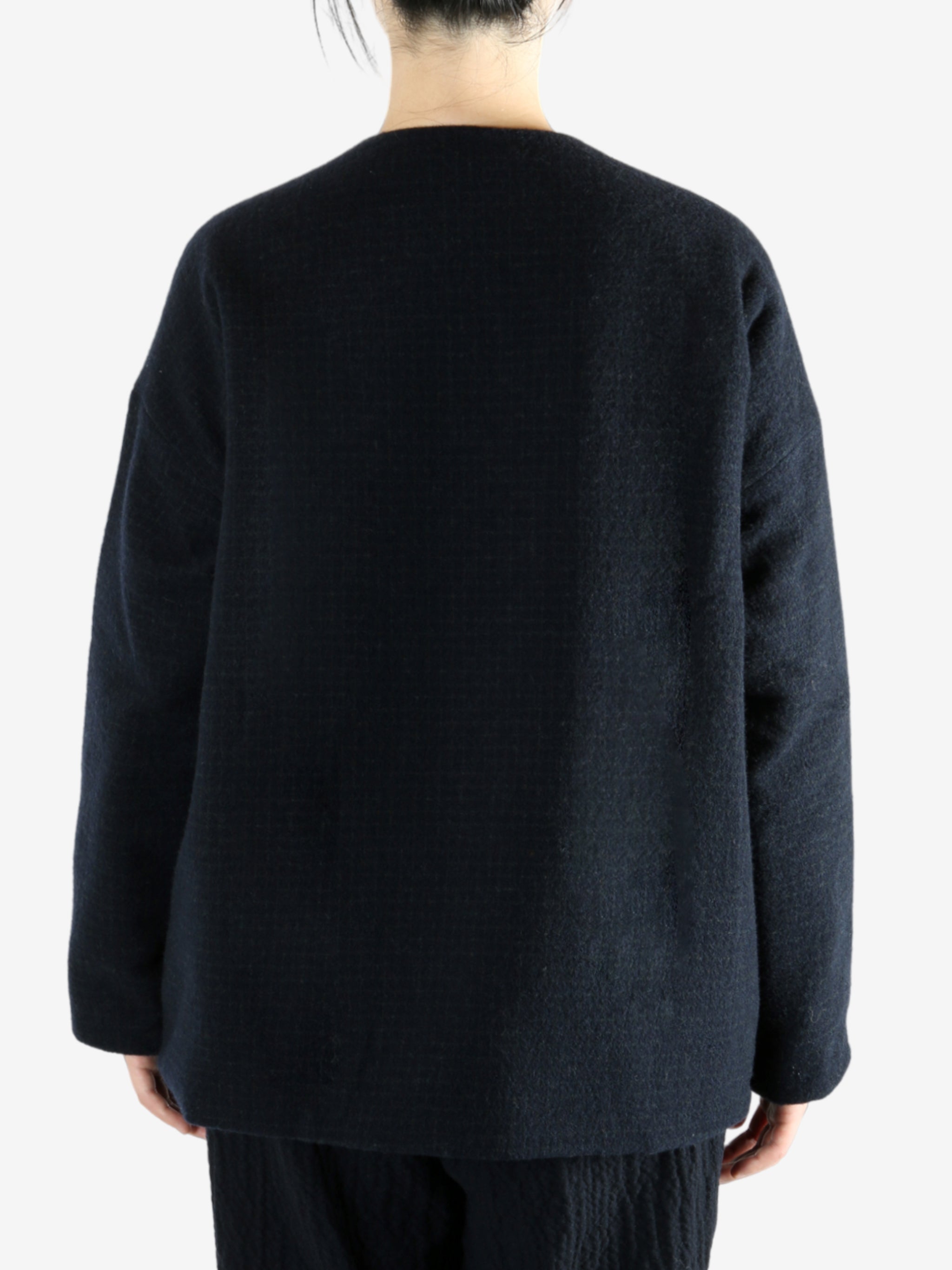 Black jacket worn by a person, showing the jacket fit