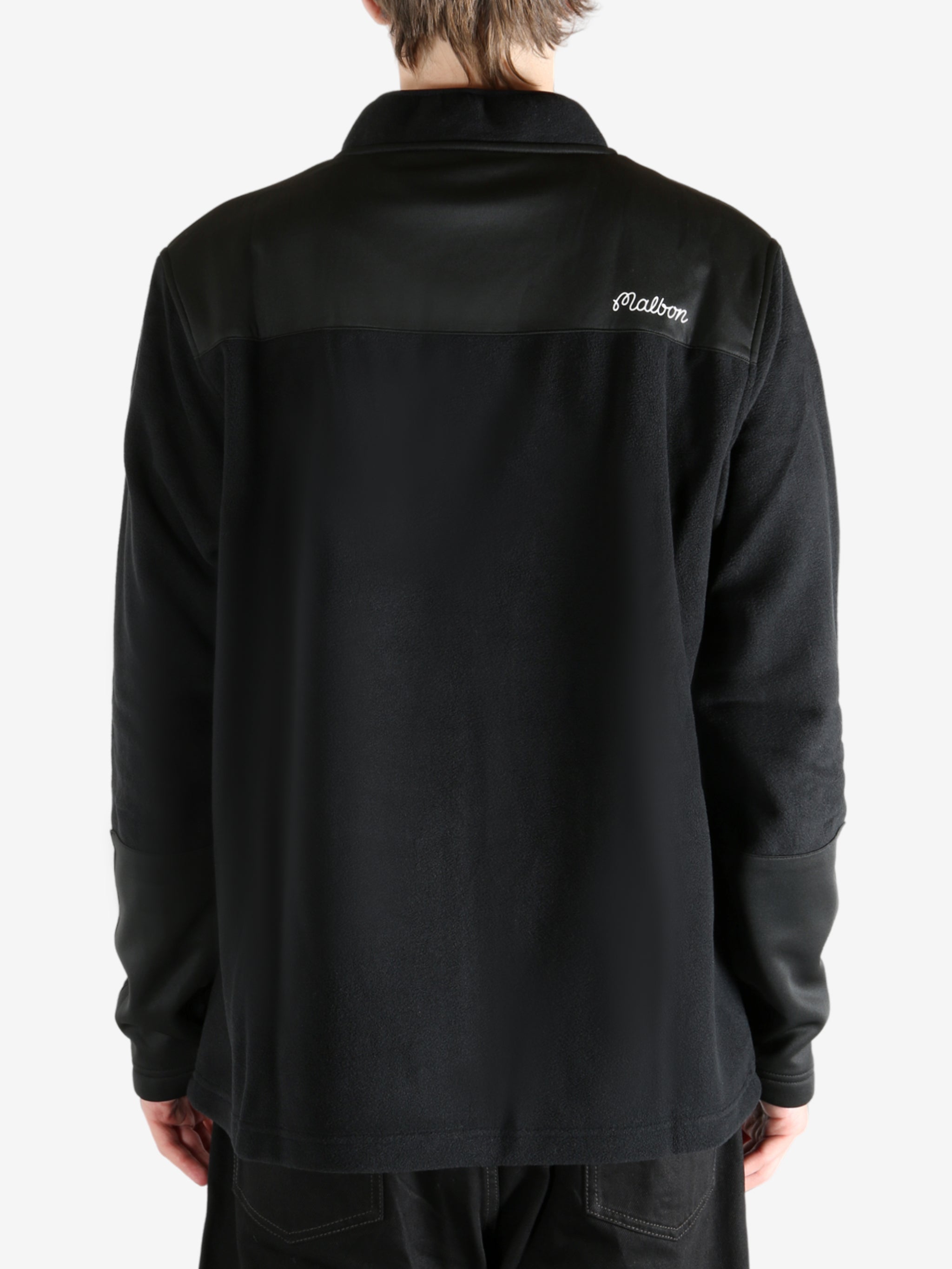 Black sweatshirt worn by a person, showing the sweatshirt's fit