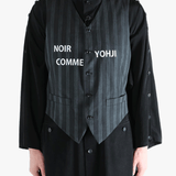 Black vest worn by a person, showing the vest's fit