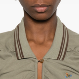 Close-up of a person wearing a green jacket with brown trim on a white background
