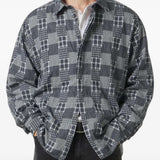 Grey shirt worn by a person, showing the shirt fit